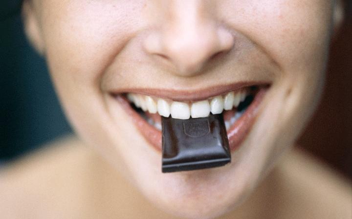 woman-eating-dark-chocolate-large